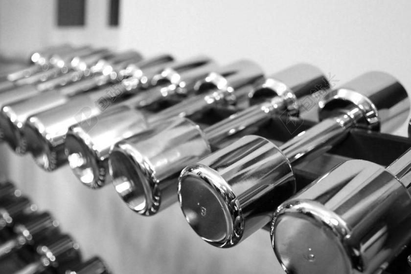 银色健身整齐架子上摆放齐整的举重器锻炼健美背景图片