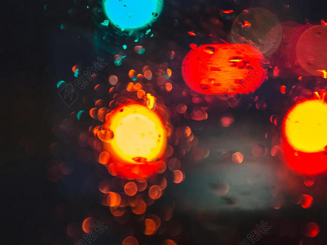 模糊散景汽车灯雨玻璃背景图片