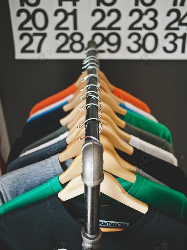 彩色服装丰富衣架上放着不同颜色的衣服服装购物展示背景图片