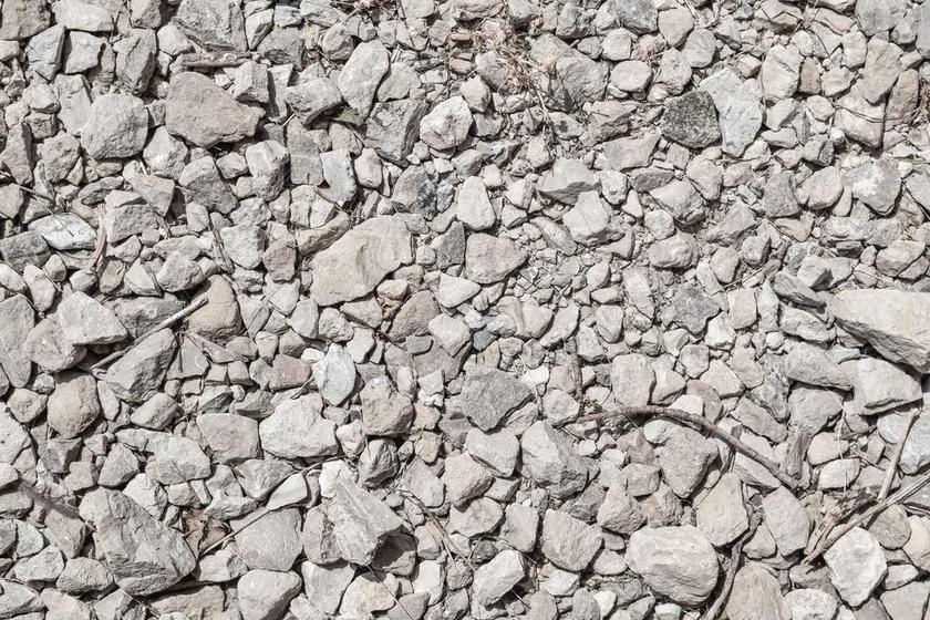 灰色纹理不规则地面上的大小石块纹理设计平面背景图片