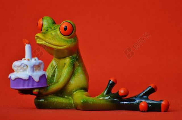 玩具快乐吹蜡烛的青蛙玩偶背景图片