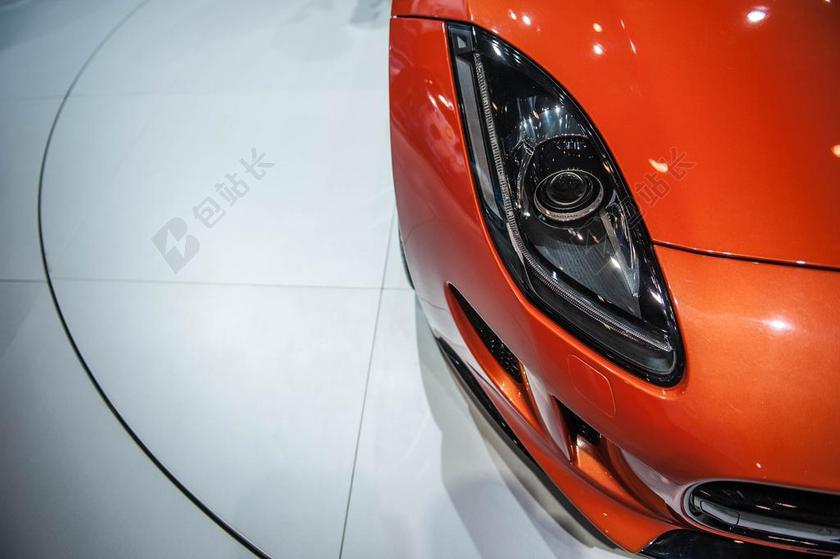 橙白汽车时尚汽车前车灯部分展示汽车设计配件背景图片