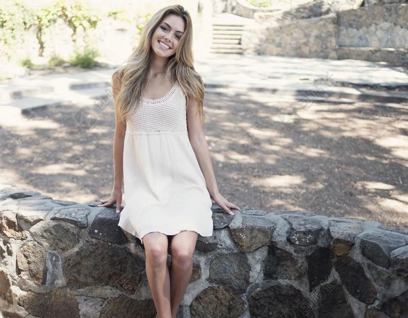 广告自然坐在石头上的微笑女士模特背景图片