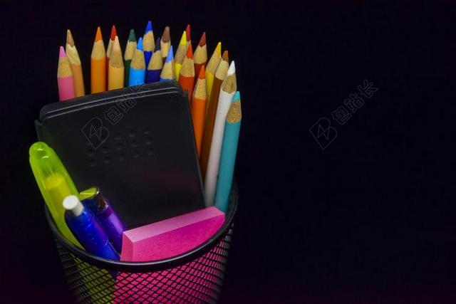 彩色文具展示笔筒中的彩色铅笔计算器便签背景图片