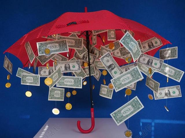 金融创意伞下面掉下很多钱币金钱保护商贸背景图片