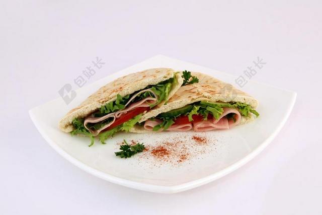 彩色食物诱人饼夹着生菜火腿等小吃美食背景图片
