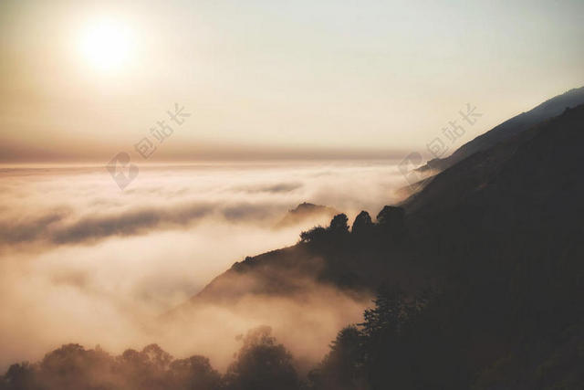 黑色的高山和白色的云雾背景图片