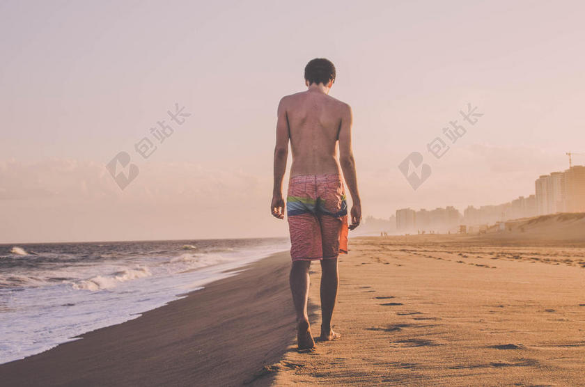 清晨的阳光和沙滩上的青年背景图片