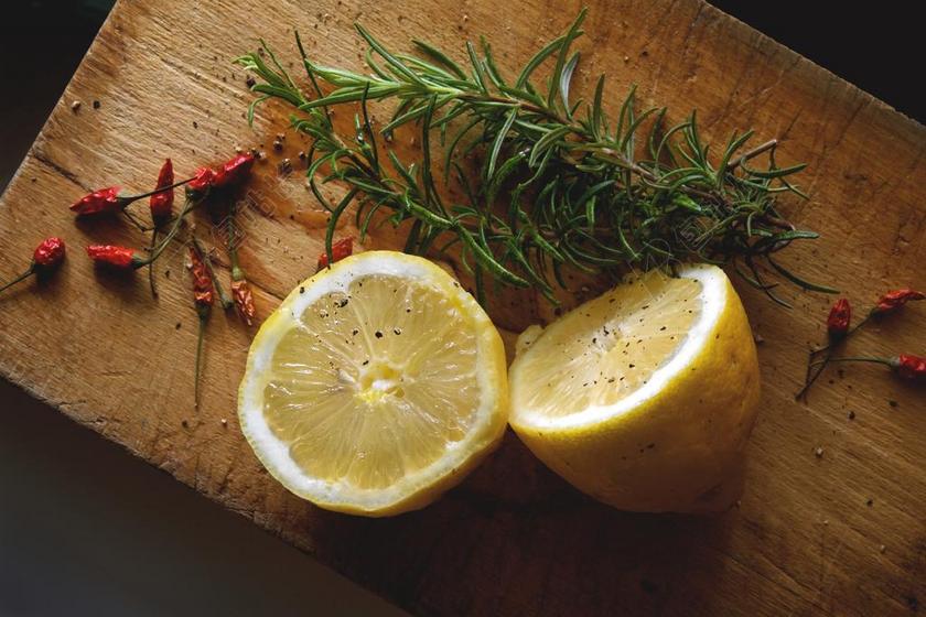 木板上的柠檬和香草背景图片